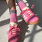 model wearing bubblegum pink socks with green stripe cuffs and pink sneakers