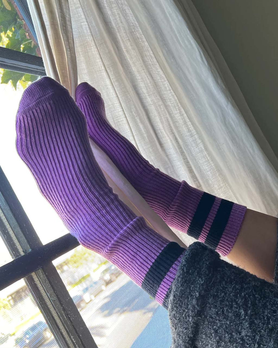 model wearing orchid socks with navy stripes