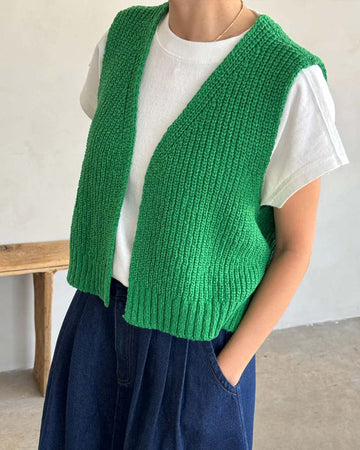 model wearing spring green knit open front 'granny' sweater vest