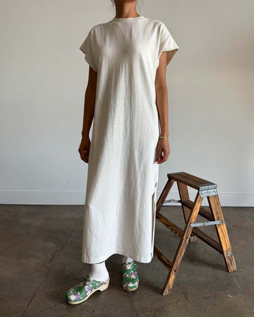 model wearing cream cotton maxi dress with muscle sleeves and side slits