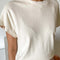 model wearing cream cap sleeve tee with side slits