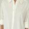 up close of model wearing white relaxed fit button front shirt with side vents and collar