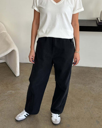 model wearing black canvas extended length arc pants