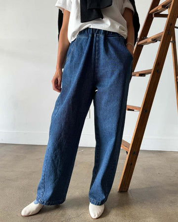 model wearing blue denim extended length arc pants