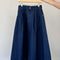 extended length denim midi skirt with button front and pockets on a hanger