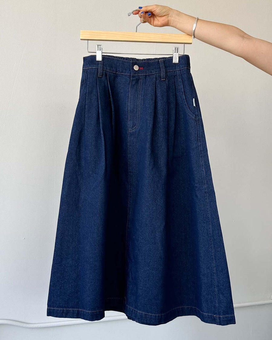 extended length denim midi skirt with button front and pockets on a hanger