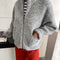 model wearing zipped heather grey fluffy jacket with collar, zip front and patch pockets