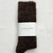 packaged model wearing dark brown  heather slouchy socks