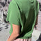 back view of model wearing artichoke relaxed fit tee with a slight crop