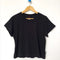 black relaxed fit tee with a slight crop on a hanger