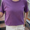 model wearing plum relaxed fit cotton tee with slight distressing on neckline and armholes
