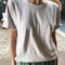 model wearing stone relaxed fit cotton tee with slight distressing on neckline and armholes