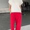 model wearing naturel short sleeve sweater top with red arc pants