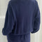 back view of model wearing navy pointelle sweatshirt with banded bottom