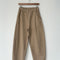 khaki arc pants with side pockets and side leg panels on a hanger