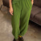 model wearing avocado green cotton balloon pants with side pockets