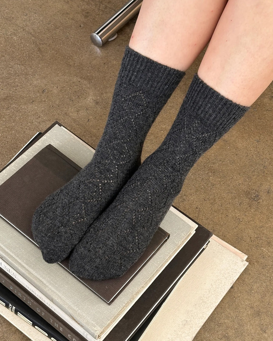 model wearing charcoal pointelle tall crew socks