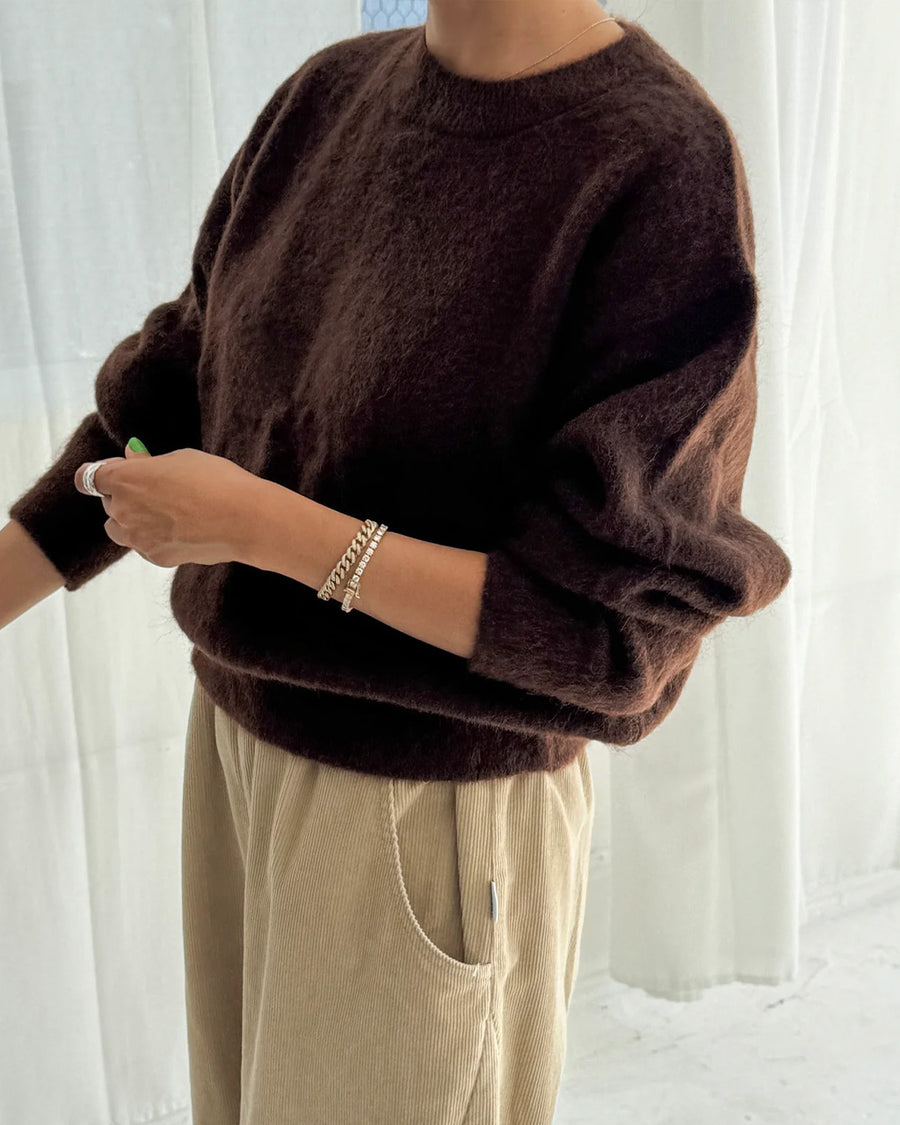 side view of model wearing dark brown mohair pull over sweater