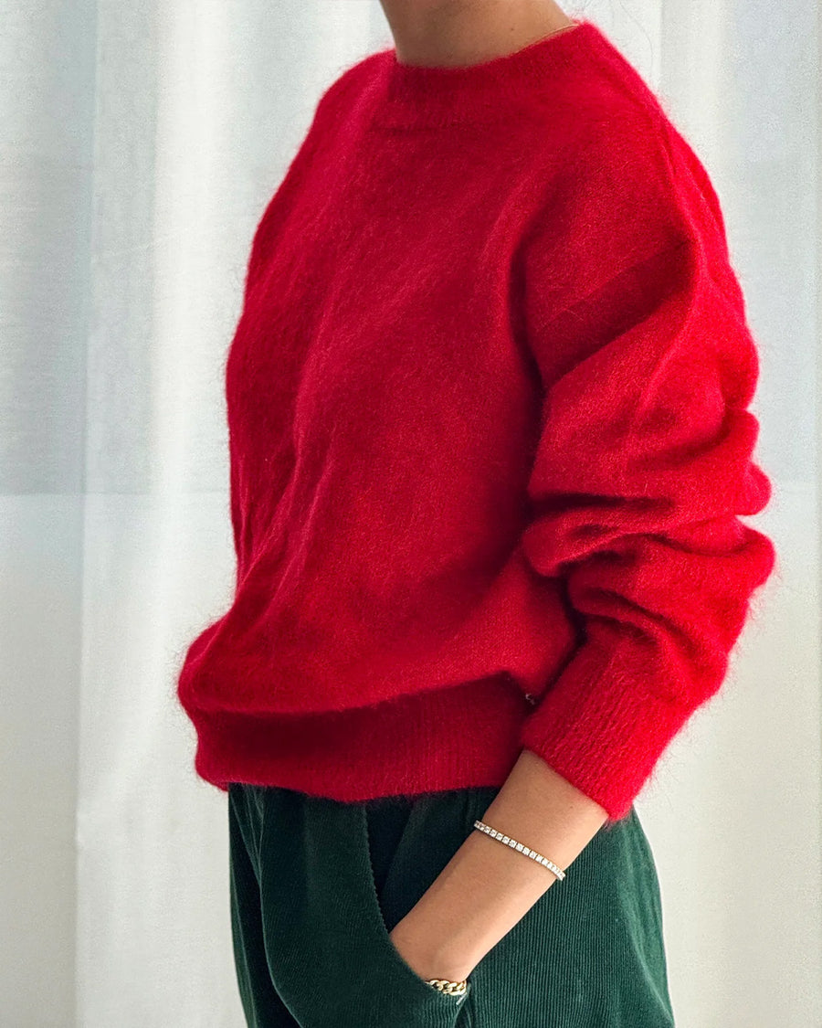 side view of model wearing red mohair pull over sweater
