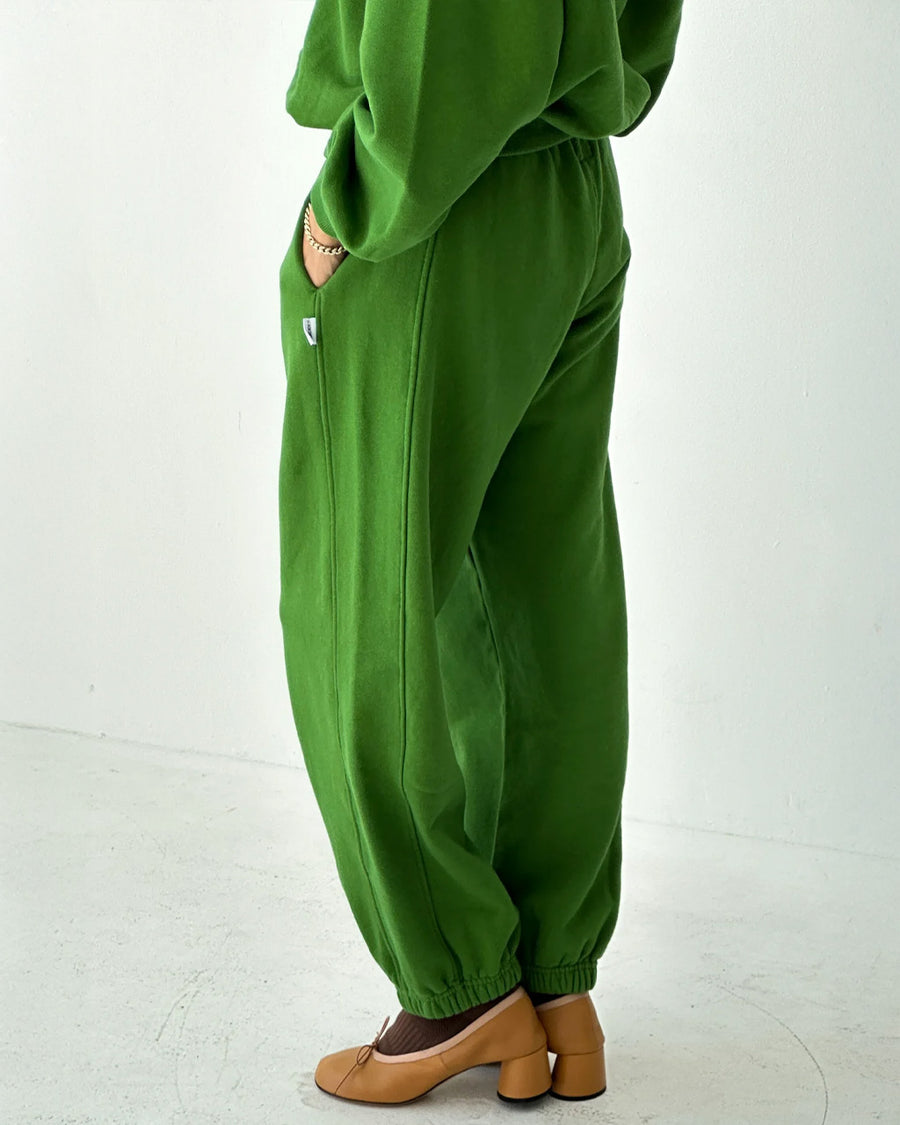 side view of model wearing avocado french terry balloon pants with side pockets and side panels