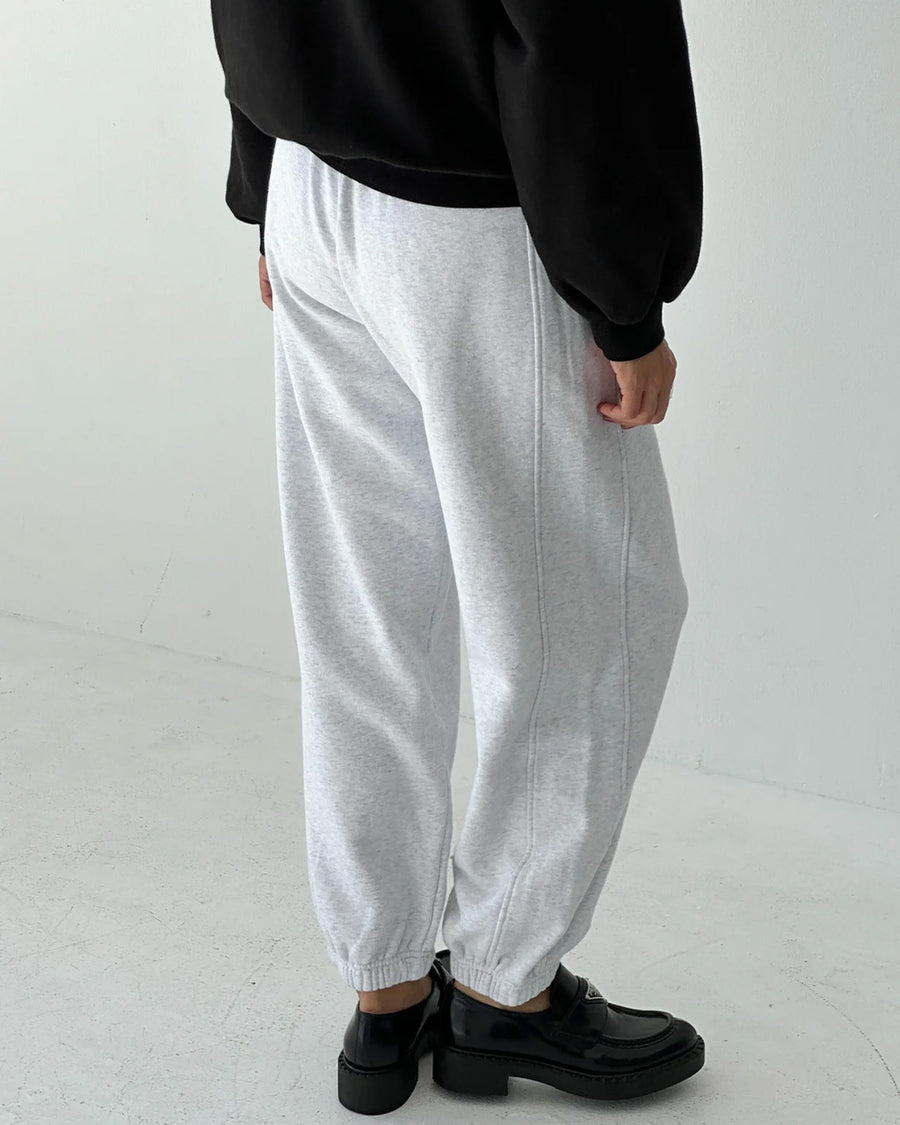 back view of model wearing icy grey french terry balloon pants with side pockets and side panels