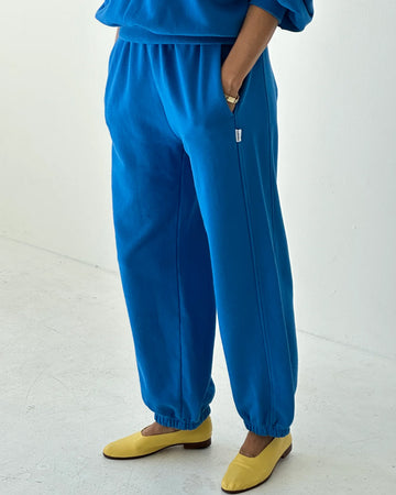 model wearing lagoon blue french terry balloon pants with side pockets and side panels