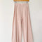 baby pink pointelle cotton balloon pants on a hanger