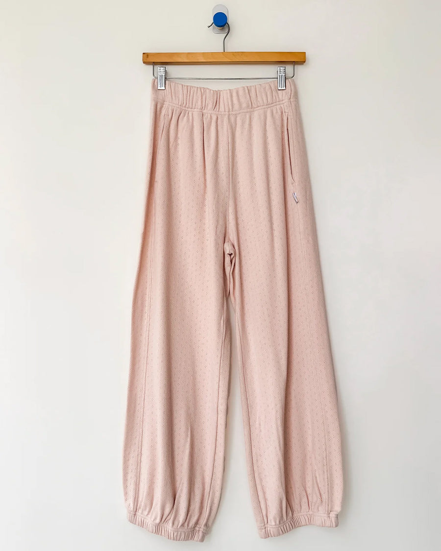 baby pink pointelle cotton balloon pants on a hanger