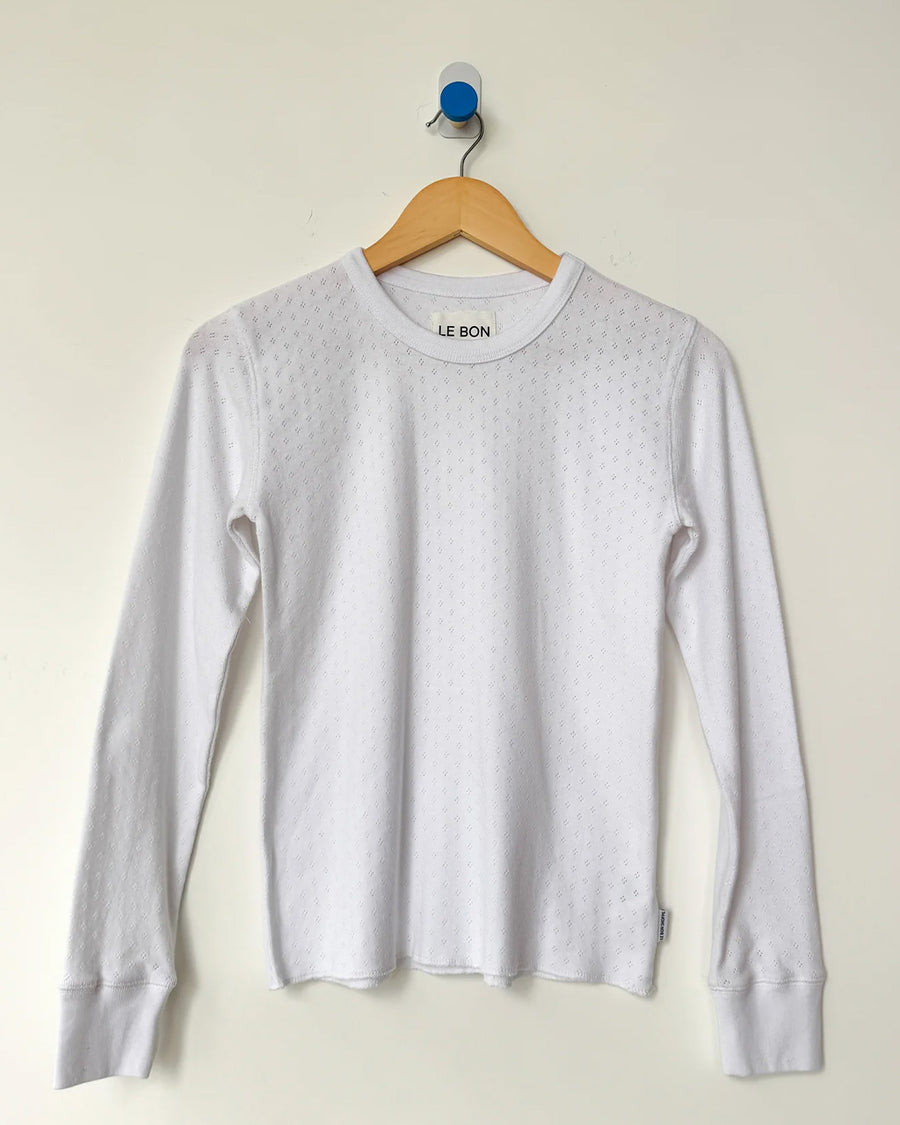 white pointelle long sleeve tee on a hanger
