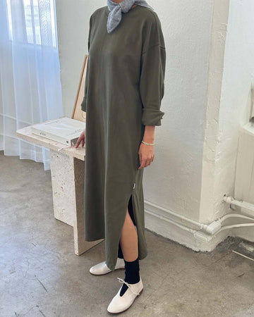 model wearing green heavy cotton maxi dress with side slots and long sleeves