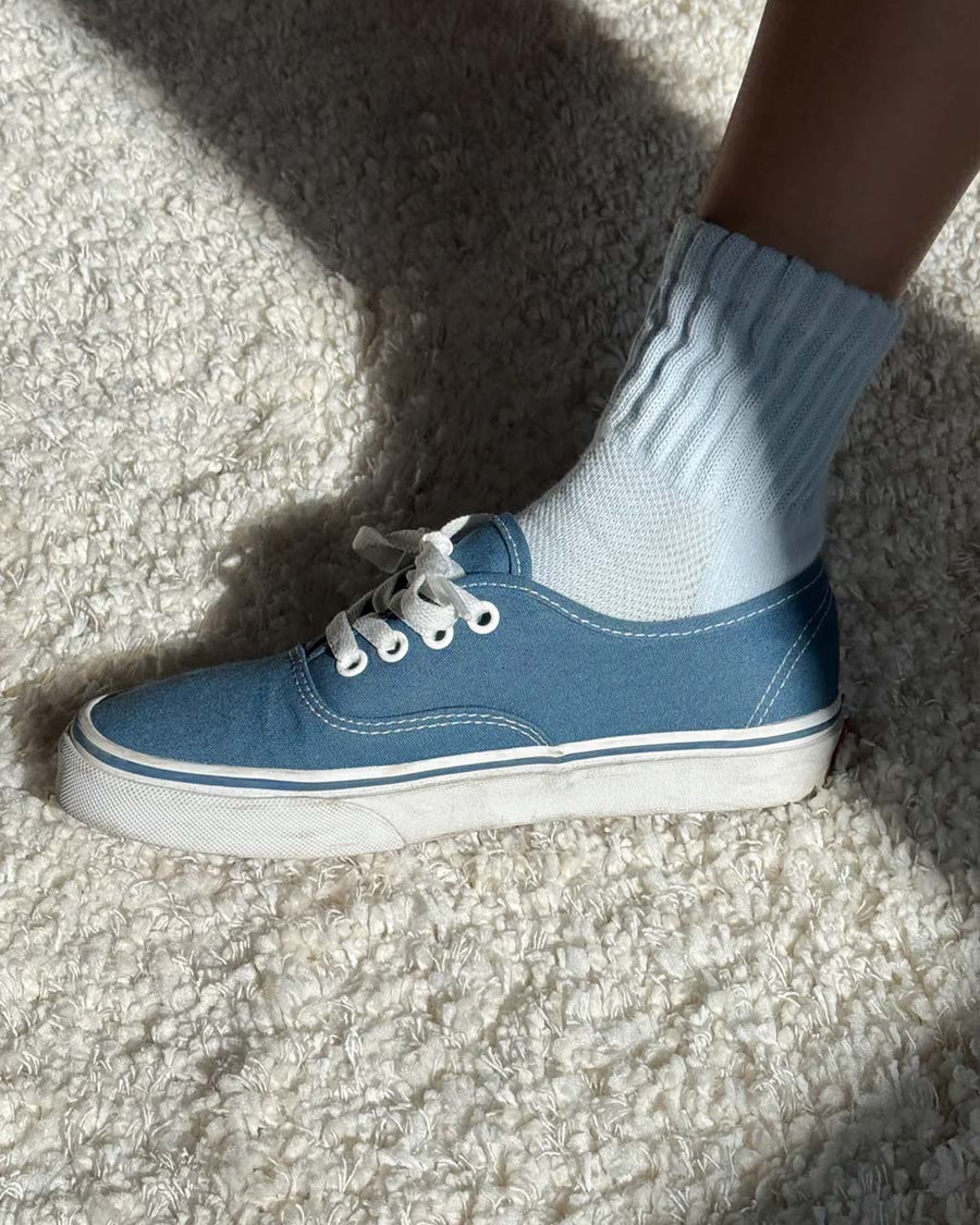 model wearing light blue socks with cushioned cuff with denim sneakers