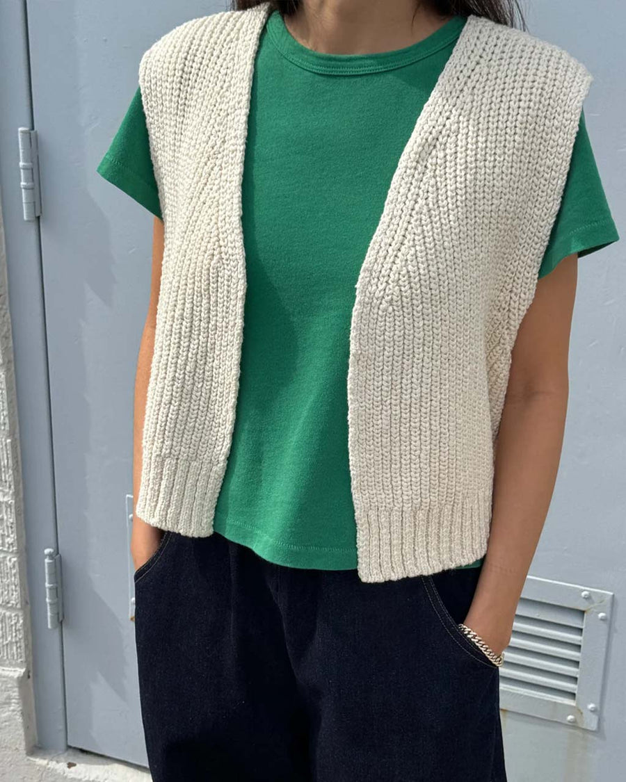model wearing sea green little boy tee with natural granny vest