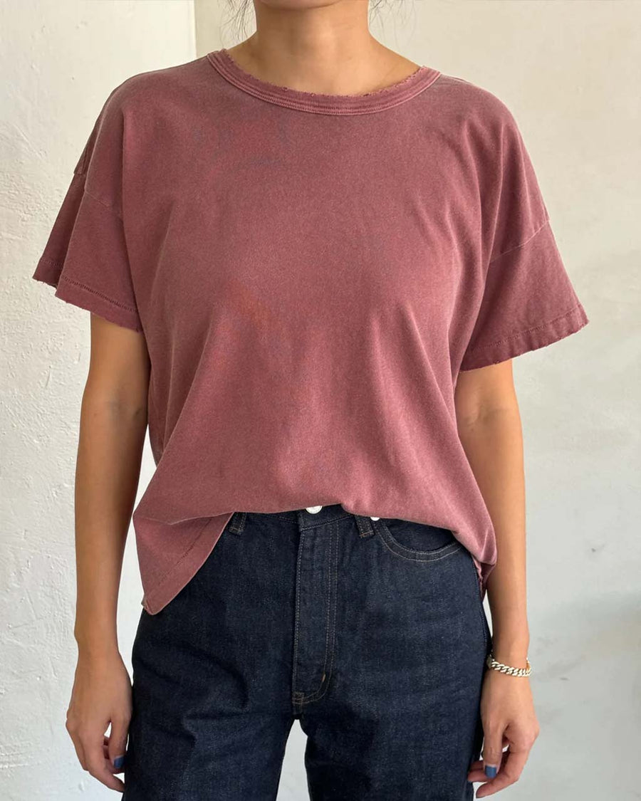 model wearing relaxed, slightly cropped brick tee with distressing on the neckline