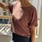 model wearing relaxed, slightly cropped brick tee with distressing on the neckline