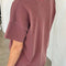 back view of model wearing relaxed, slightly cropped brick tee with distressing on the neckline
