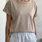 model wearing relaxed, slightly cropped mushroom tee with distressing on the neckline