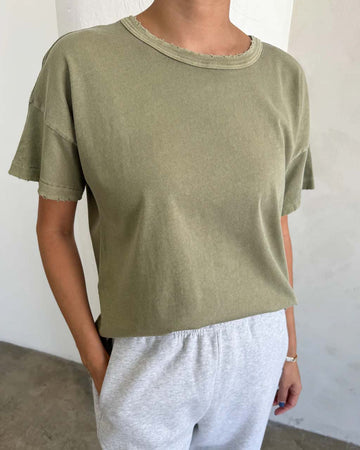 model wearing pistachio relaxed tee with light distressing