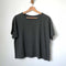 relaxed, slightly cropped washed black tee with distressing on the neckline on a hanger