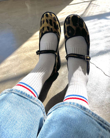 model wearing white ribbed socks with red and blue stripes