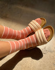 model wearing high clay and white striped socks with sandals