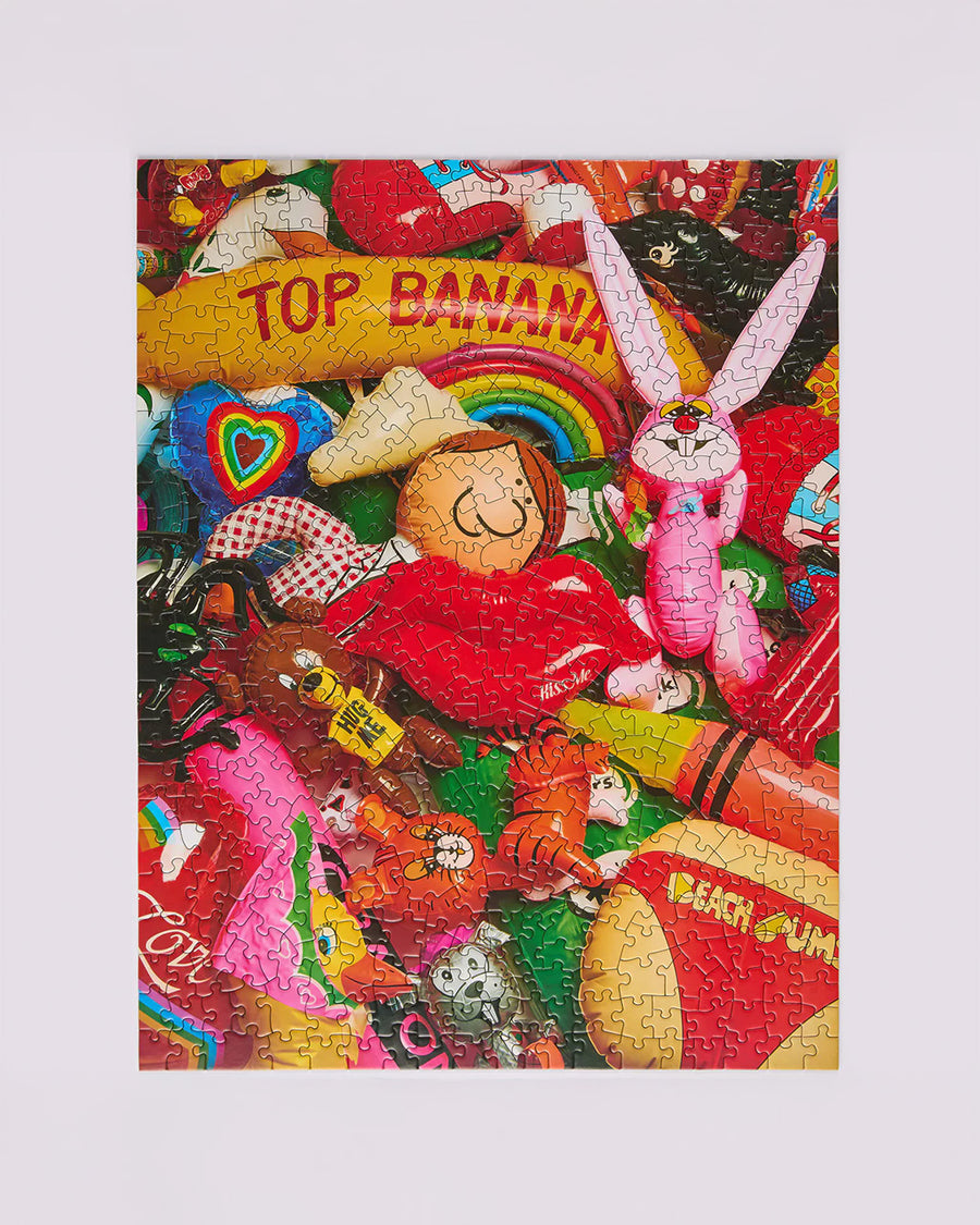 completed 500 piece puzzle with realistic colorful retro inflatables piled on each other