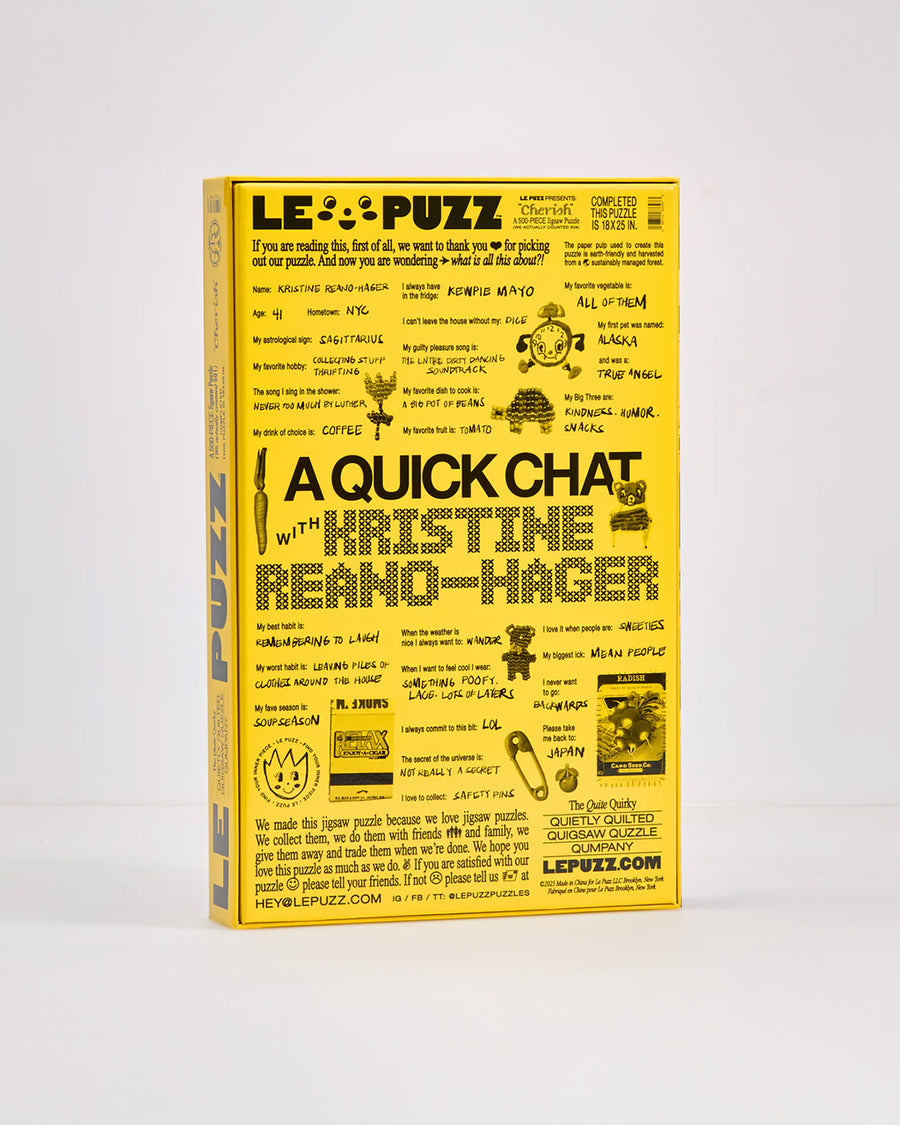 back view of 500 piece puzzle with various textiles and trinkets