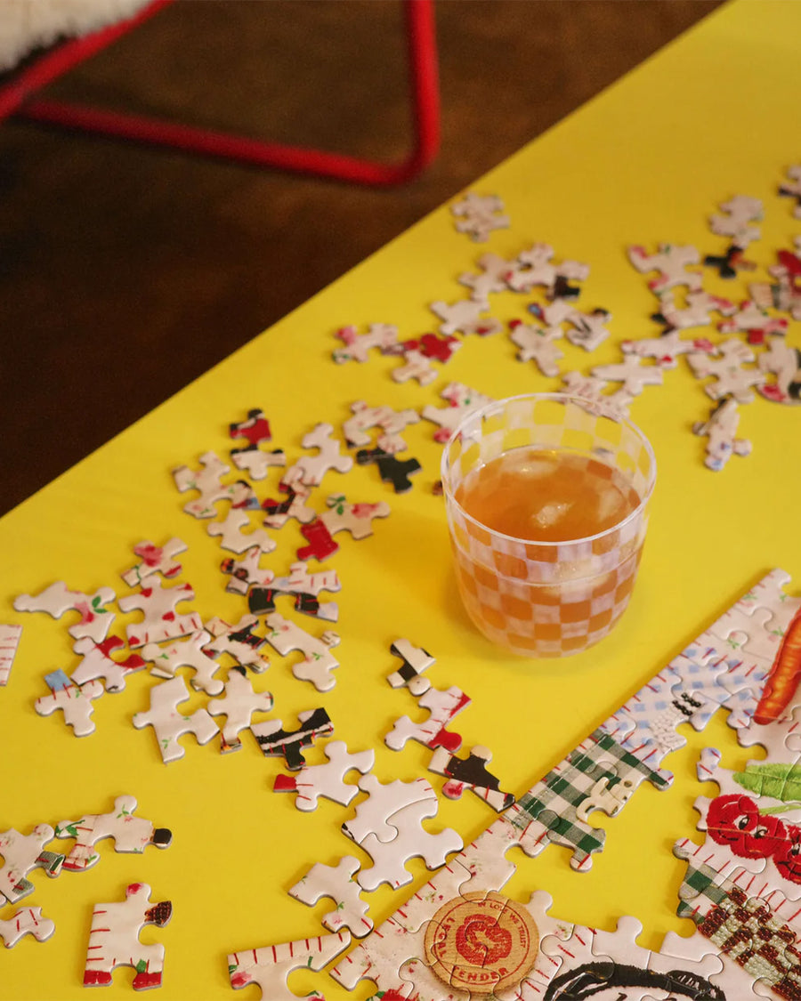 up close of 500 piece puzzle with various textiles and trinkets