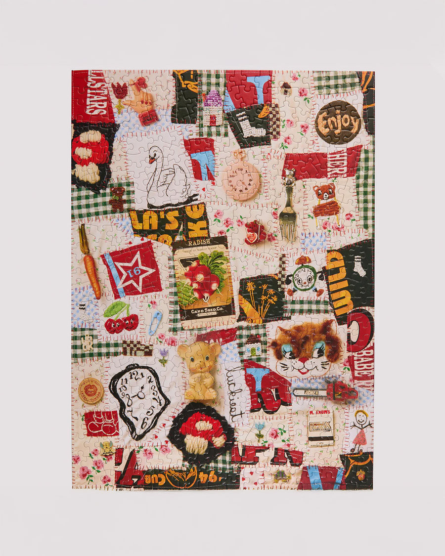 completed 500 piece puzzle with various textiles and trinkets