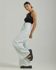 sideview of model wearing bleached denim with high waist, double button closure and wide legs
