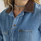 up close of model wearing denim union-all with zipper front and brown corduroy collars