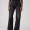 up close of model wearing low rise washed black wide leg jeans 
