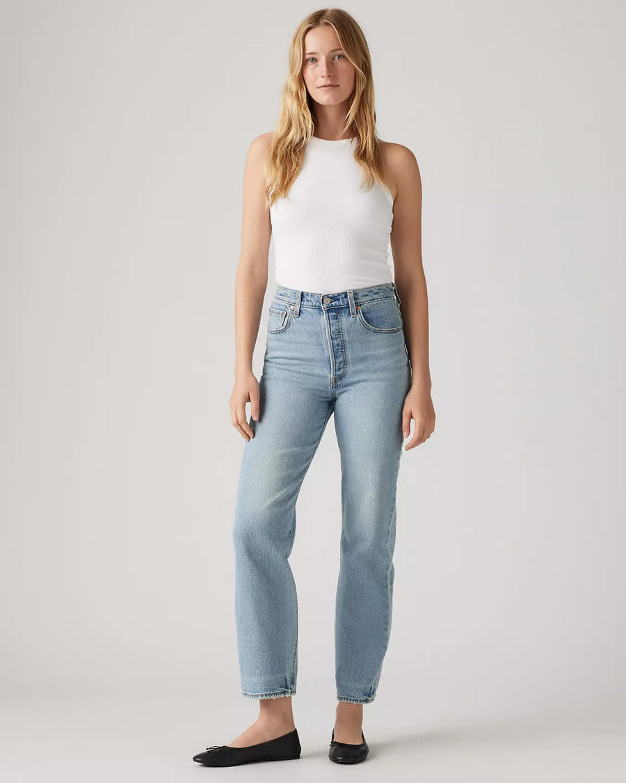 model wearing light wash ribcage straight ankle jeans