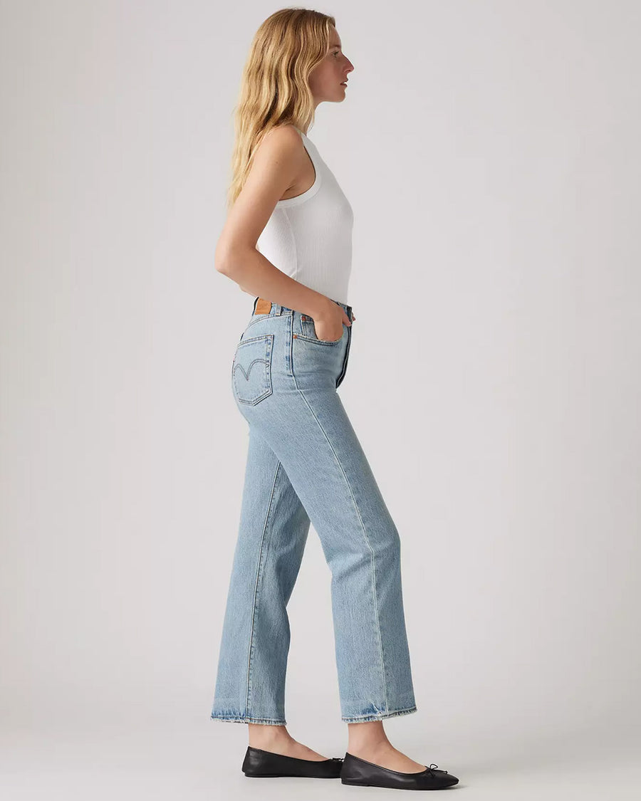 side view of model wearing light wash ribcage straight ankle jeans