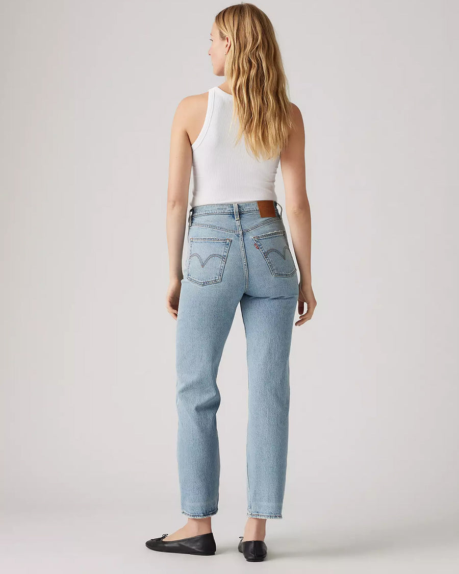 back view of model wearing light wash ribcage straight ankle jeans